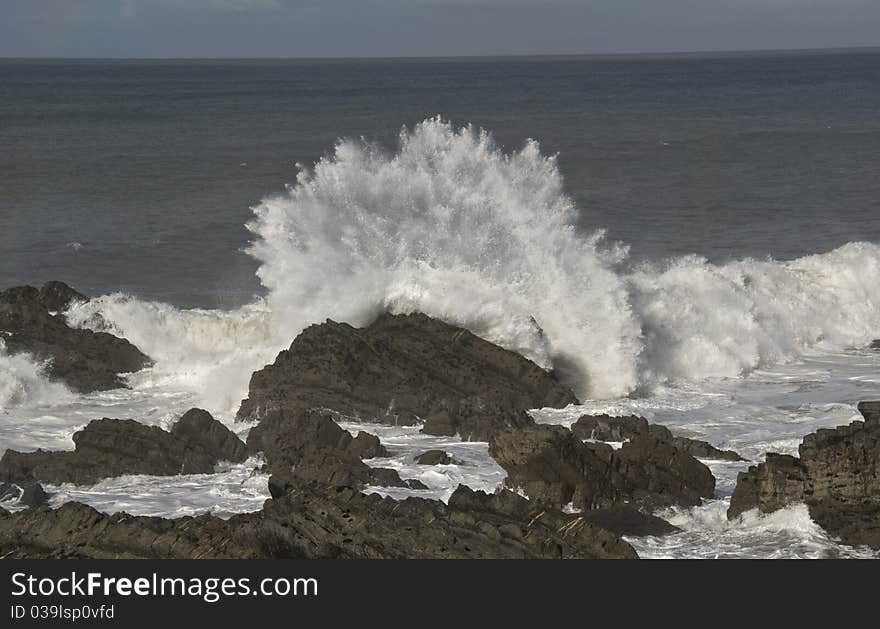 North Devon rocky coast, wave crashing into rock as the tide comes in. North Devon rocky coast, wave crashing into rock as the tide comes in.