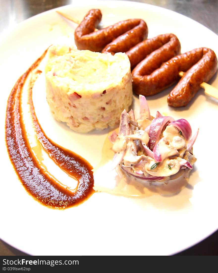 Sausage-shaped Viper with roasted potatoes and vegetable chutney and plum sauce. Sausage-shaped Viper with roasted potatoes and vegetable chutney and plum sauce