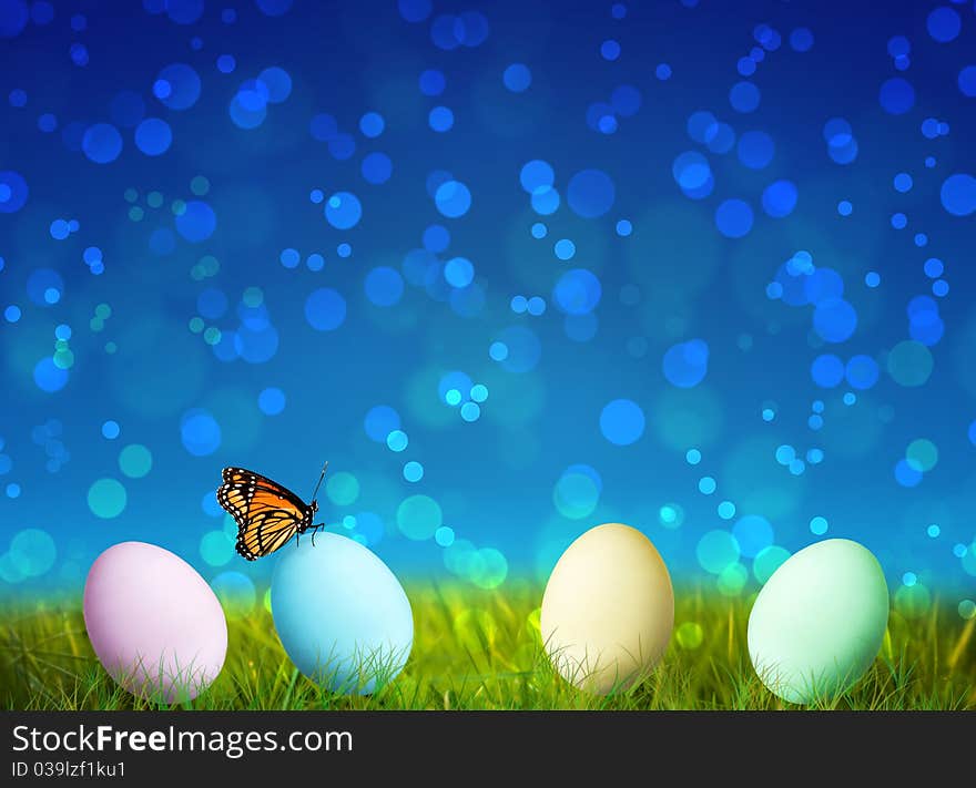 Colorful Easter Eggs on green grass with bokeh background