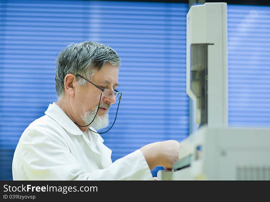 Senior male researcher carrying out scientific research in a lab (shallow DOF; color toned image). Senior male researcher carrying out scientific research in a lab (shallow DOF; color toned image)