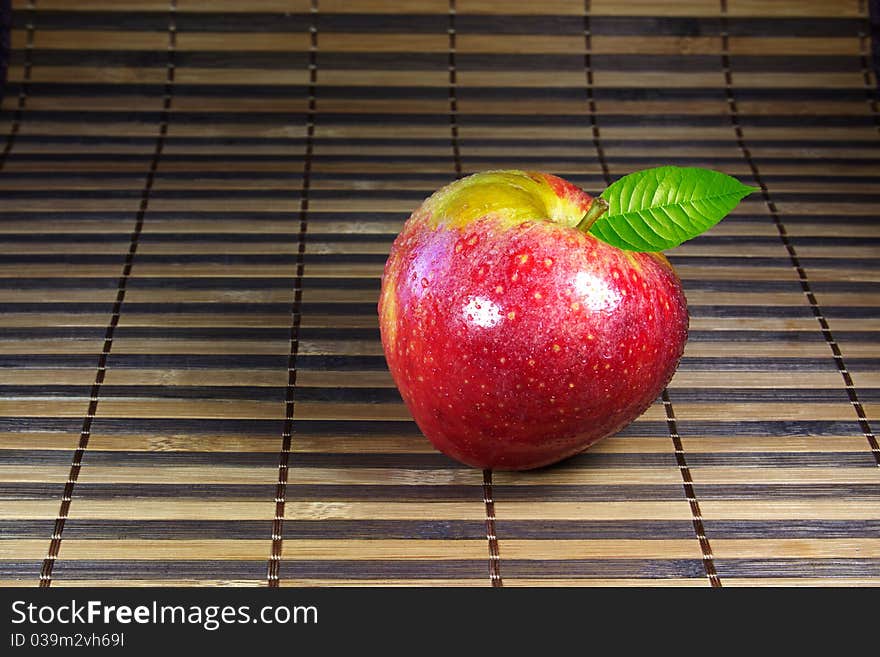 Fresh crunchy red apple on bamboo mat. Fresh crunchy red apple on bamboo mat.