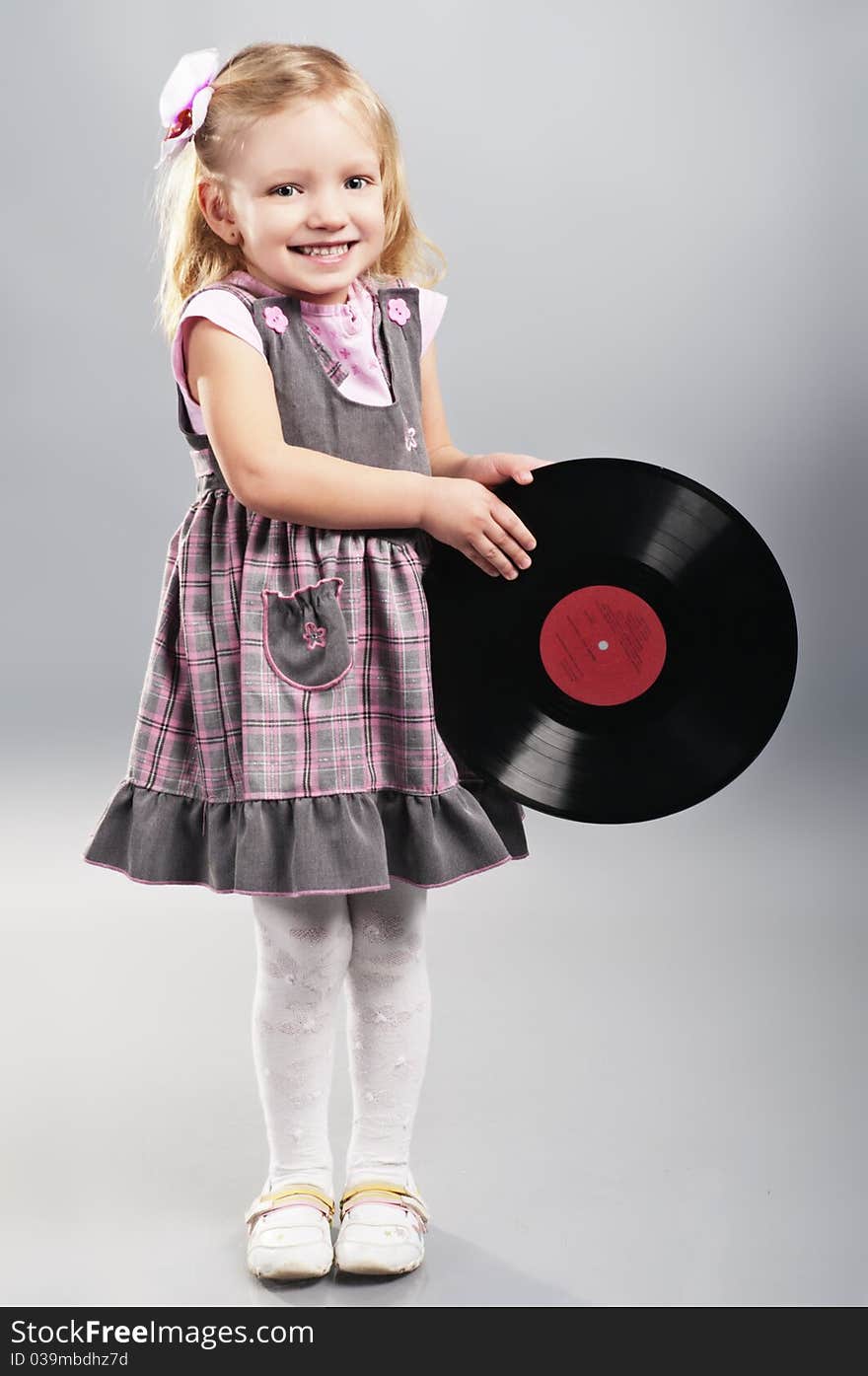 Portrait of attractive little girl with vinyl record. Portrait of attractive little girl with vinyl record