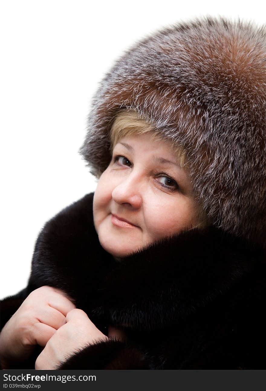 Beautiful woman wearing in fur hat and in fur coat on a white background