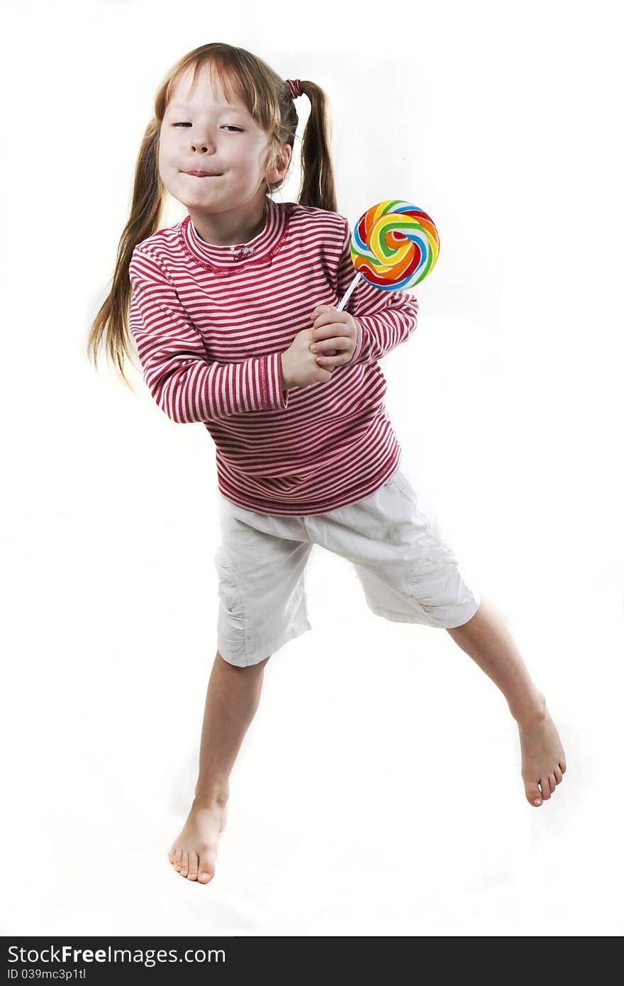 Little girl eats a lollipop isolated on white