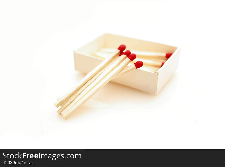 Red matches isolated on white background, make a pattern.