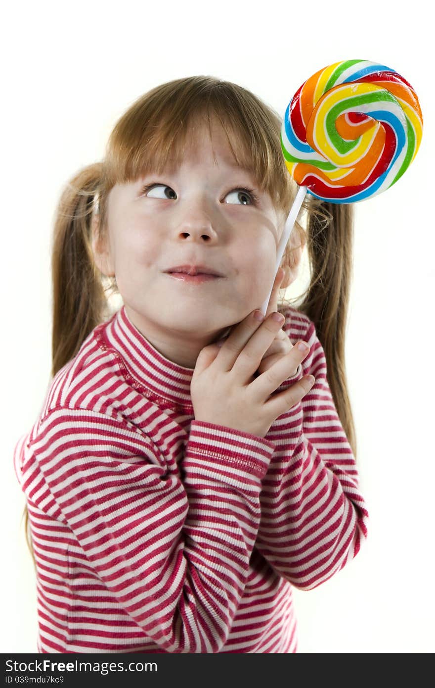 Portreit of a little girl eating a lollipop