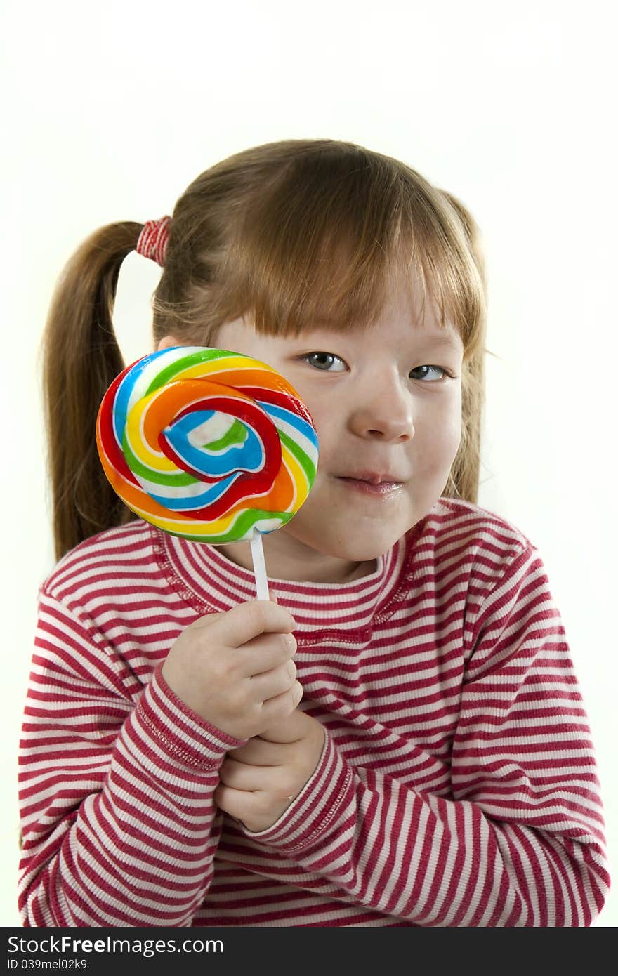 Portreit of a little girl eating a lollipop