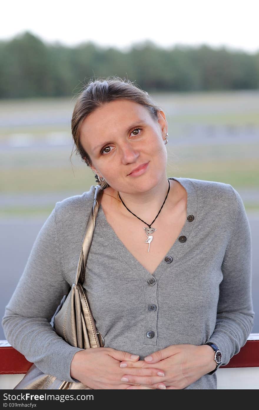 Portrait of young woman with dark hair in the summer evening