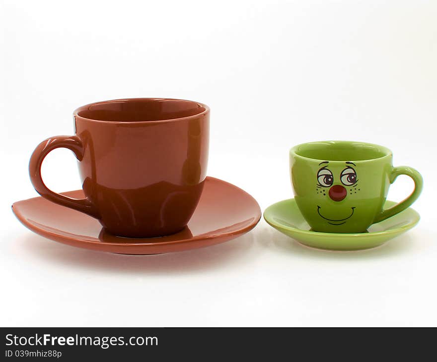 A Brown Cup Beside a Green Kid's Cup on the white background