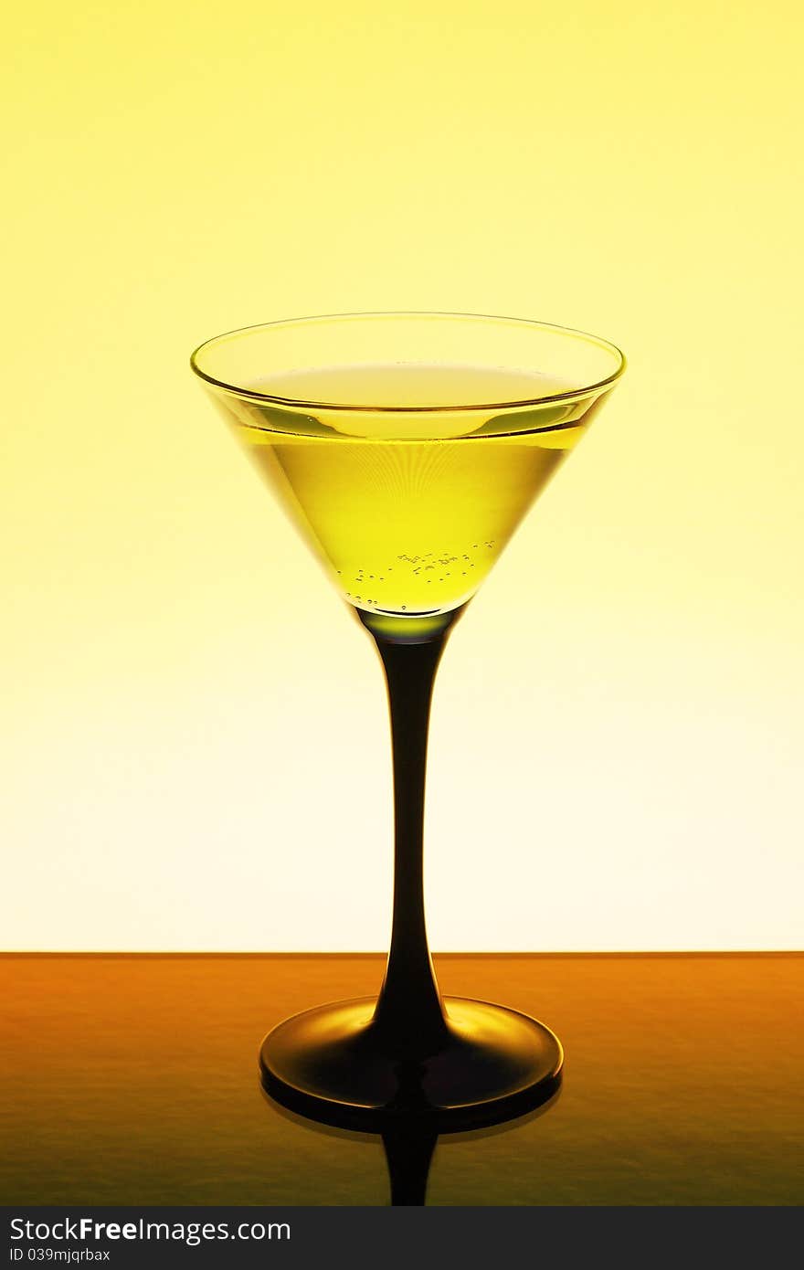 Wine in a glass on a yellow background. Wine in a glass on a yellow background