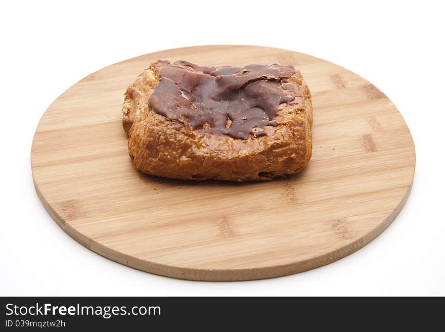 Pastry with chocolate onto wood plates