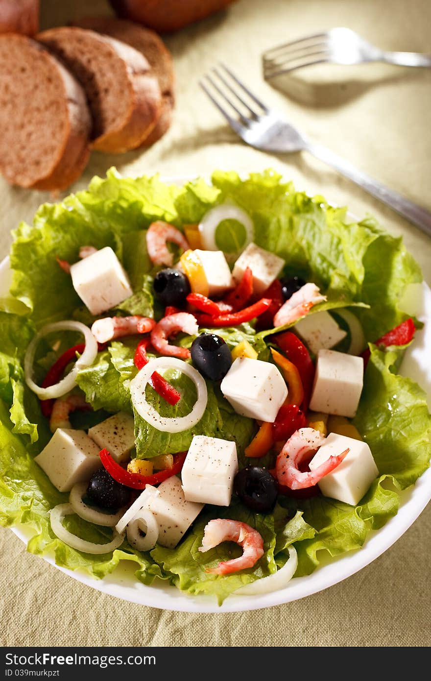 Appetizing salad with prawns on a plate