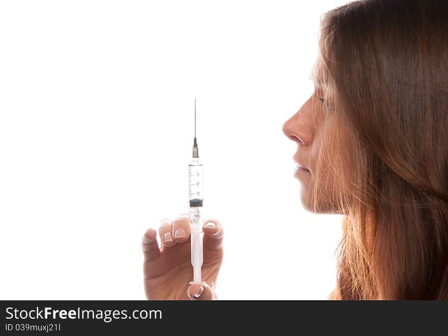 Young female doctor holding a syringe isolated on a white background