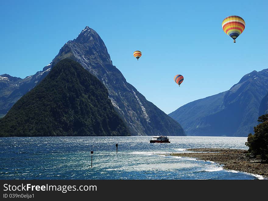 Colorful balloon flying above Milford Sound, NZ. Colorful balloon flying above Milford Sound, NZ