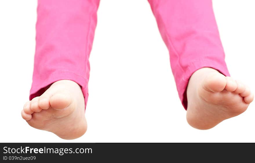 Child hangs down legs on white