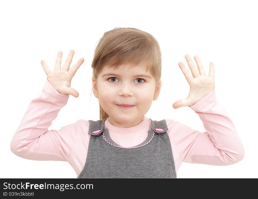 Little girl rises hends up and shows ten fingers on white