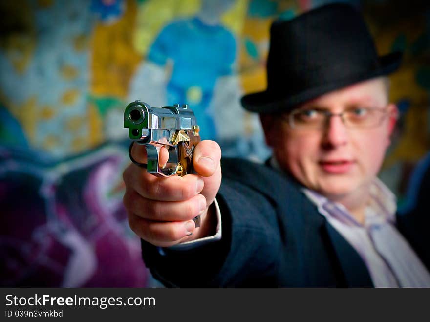 Man aiming with gun. Close-up shot on gun