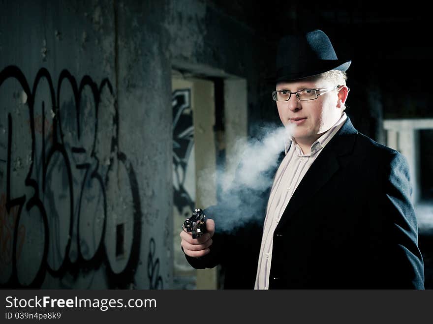 Detective smoking with gun