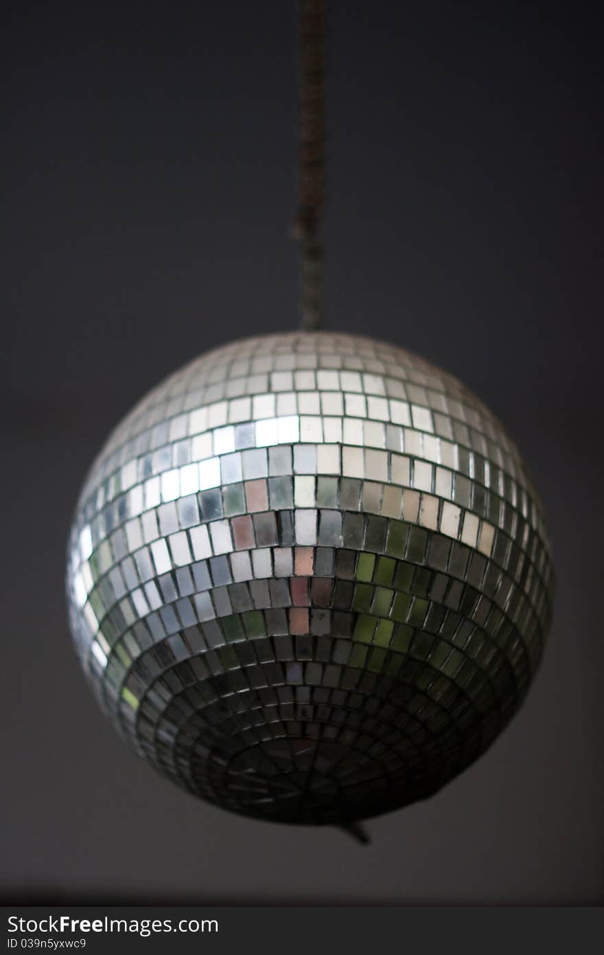 Image of the mirror  ball on a gray ceiling