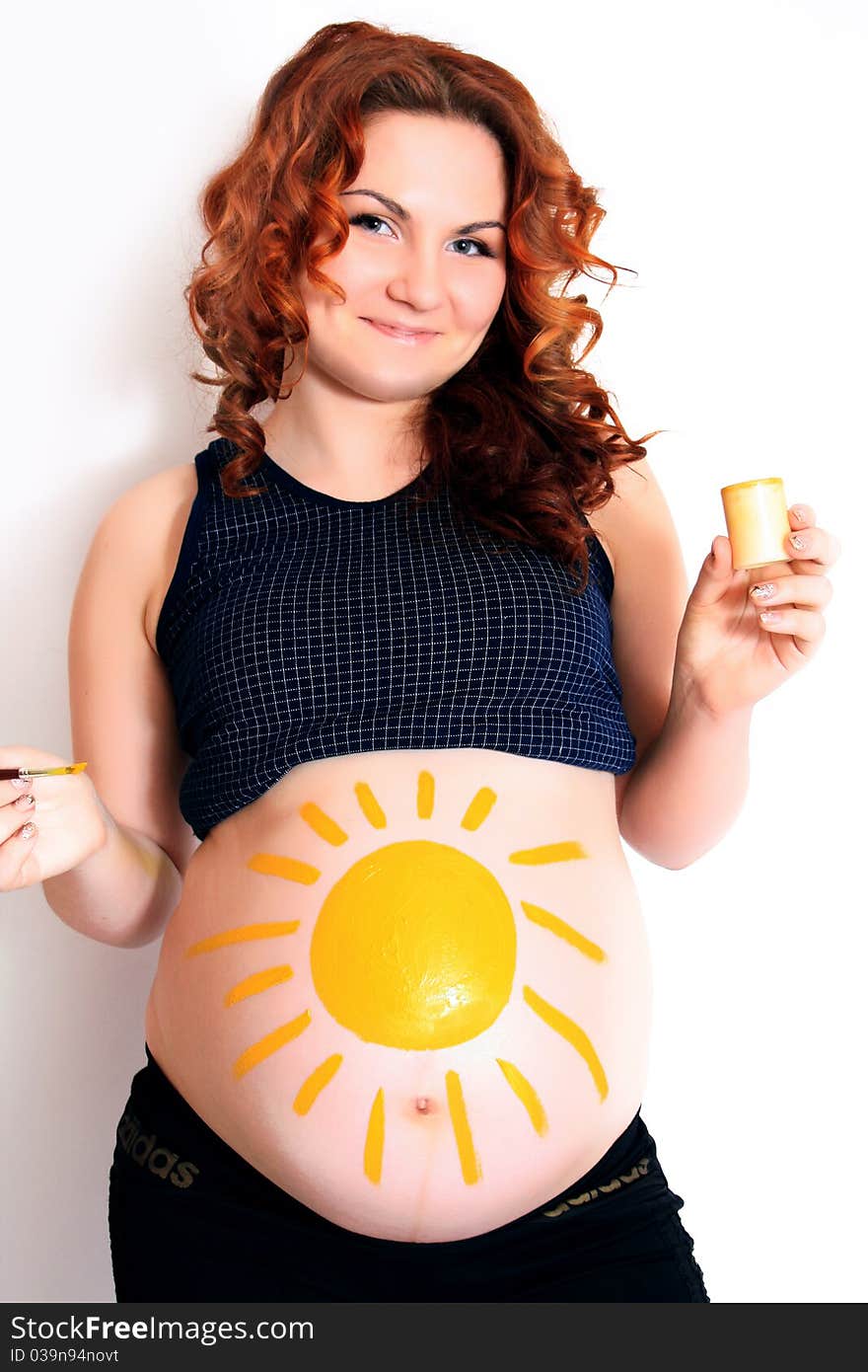 Conceptual image of happy pregnant female with painted pictures on her belly