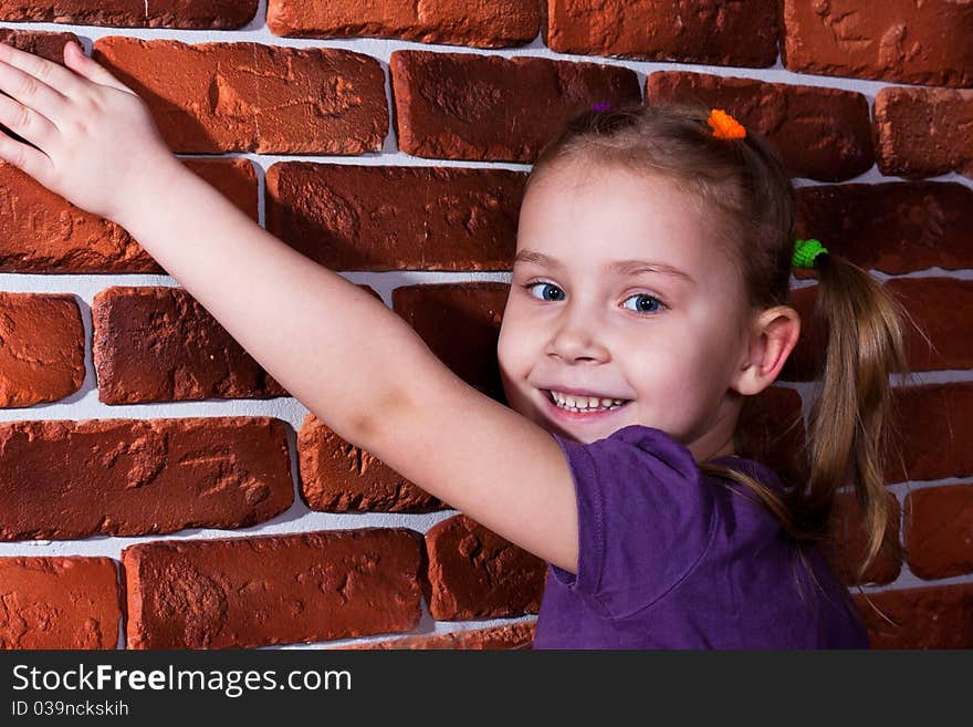 Beautiful smiling girl leaning against the break wall. Beautiful smiling girl leaning against the break wall