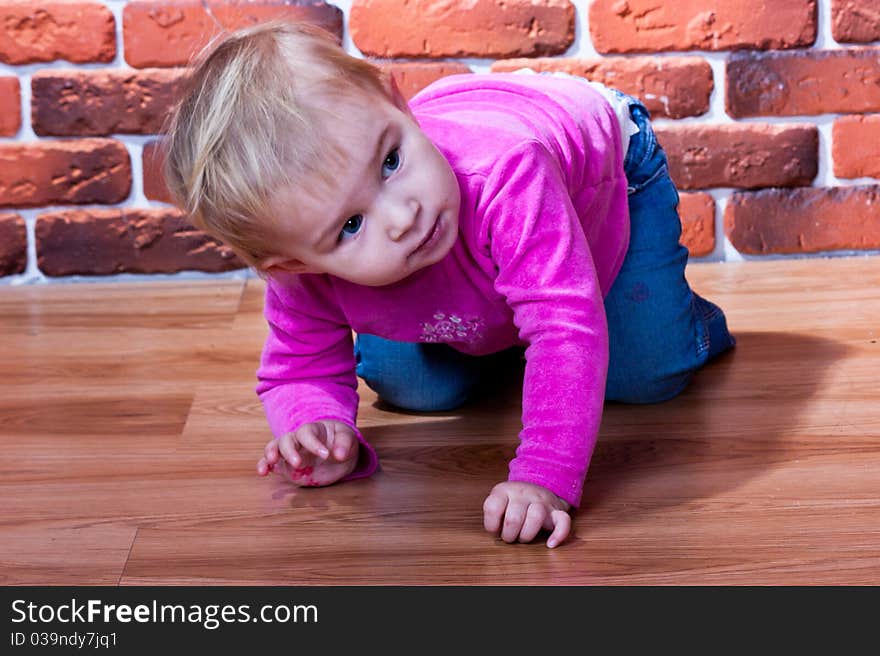 Beautiful baby crawling on the wooden floor. Beautiful baby crawling on the wooden floor