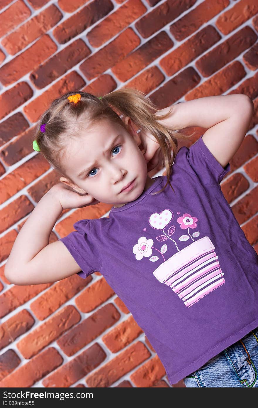 Beautiful serious girl against the break wall. Beautiful serious girl against the break wall