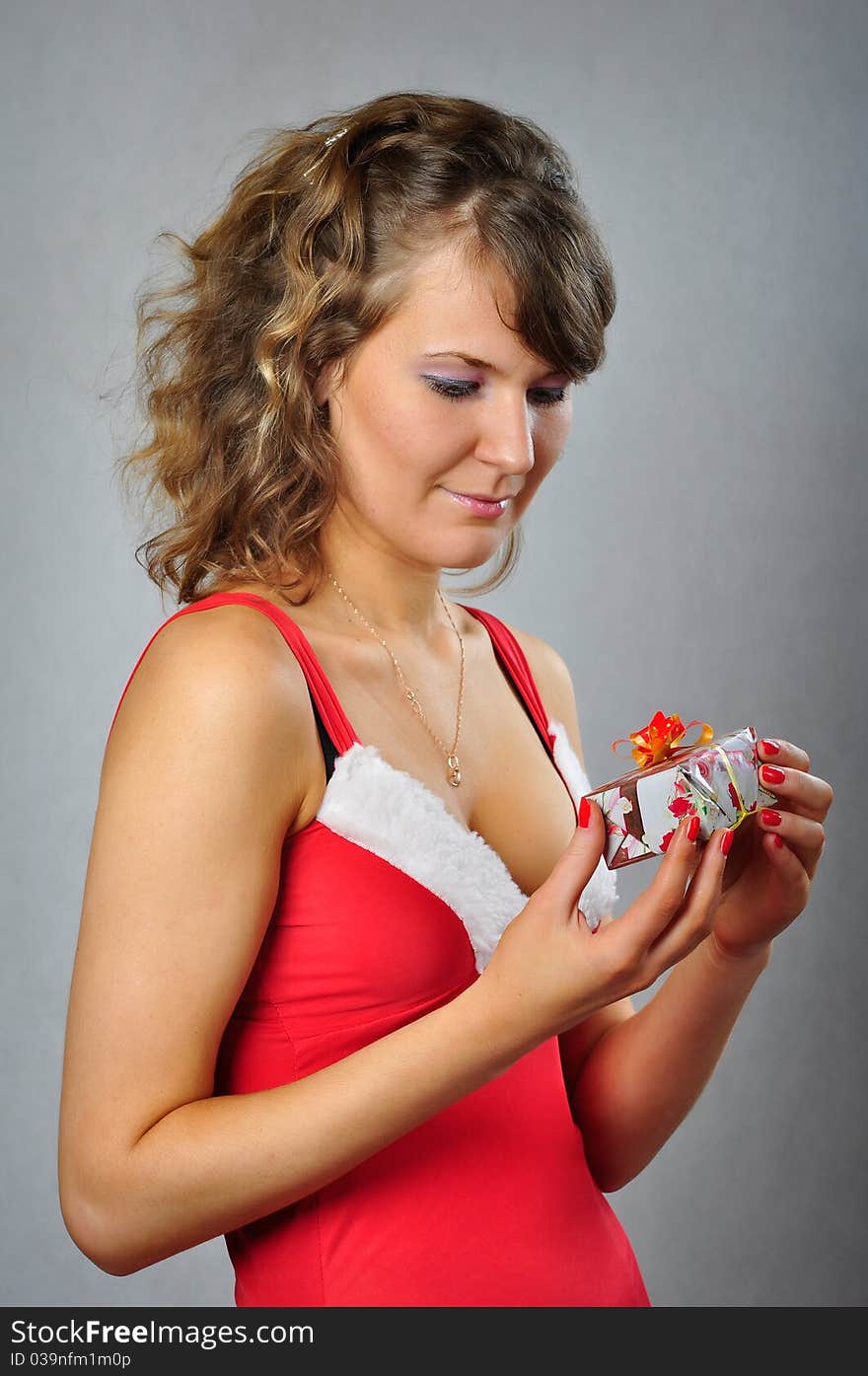 Young woman with the gift in the hands. Young woman with the gift in the hands.