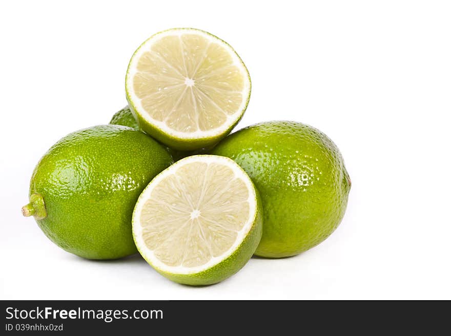 Pile of green limes across white