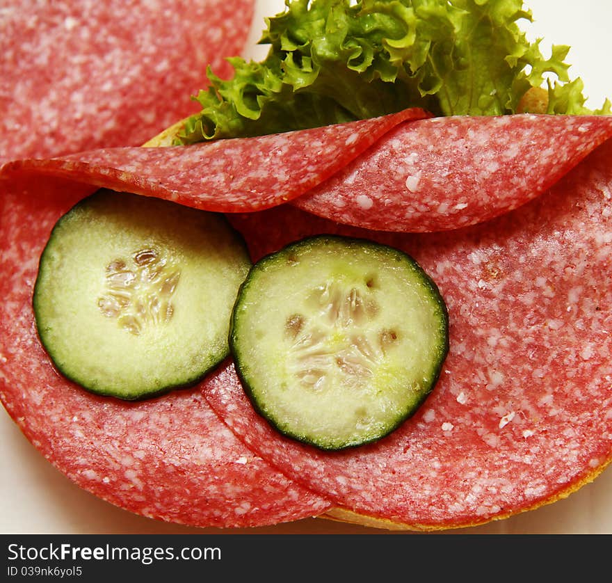 Sandwiches with sausage salad and a fresh cucumber