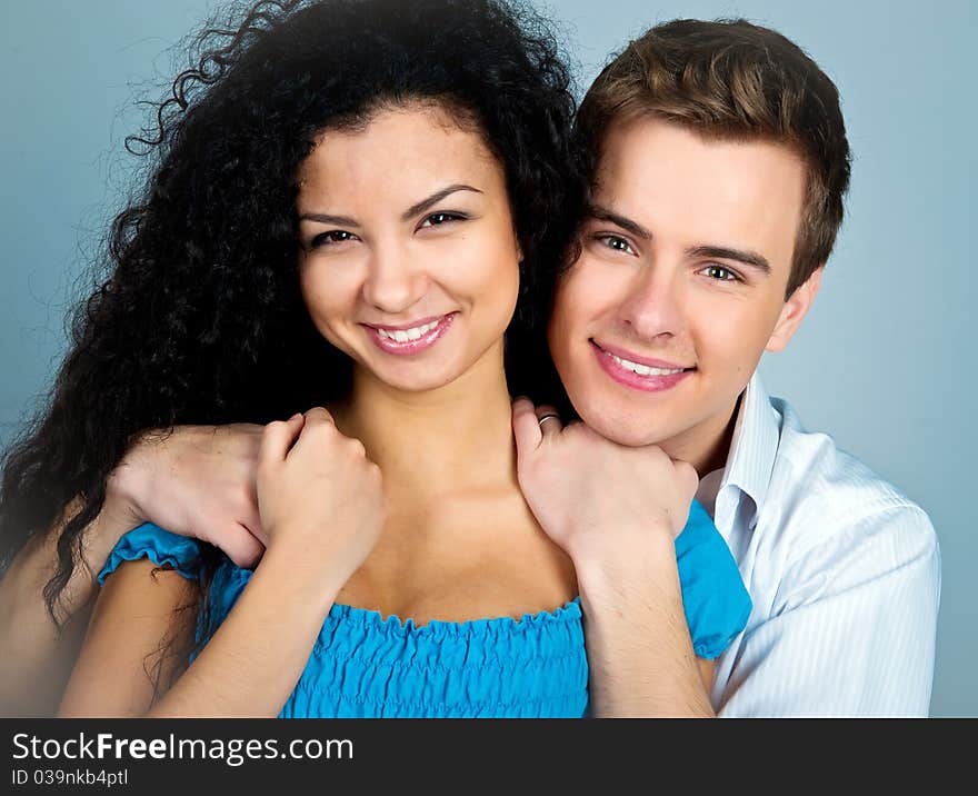 Smiling couple isolated on a greybackground