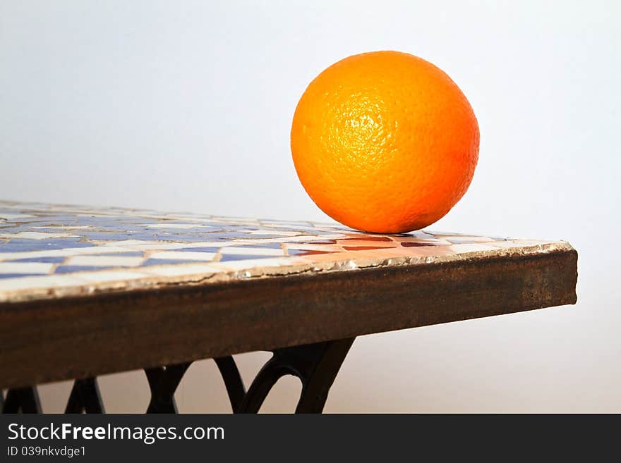 Fresh Orange in front of a blue wall. Fresh Orange in front of a blue wall