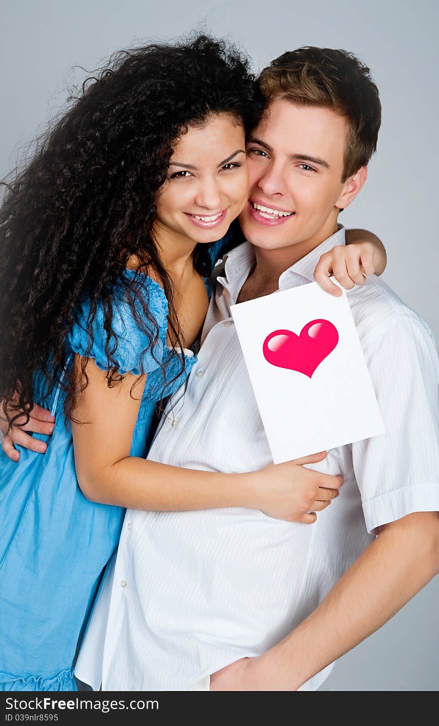 Smiling couple isolated on a greybackground