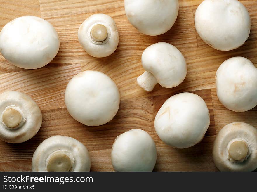 Whole Champignons on wooden background