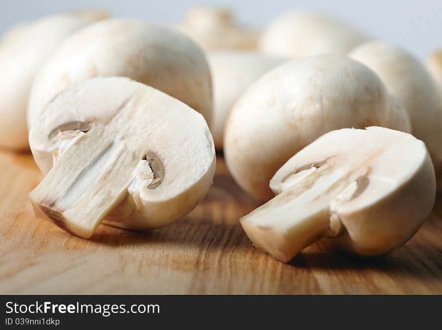 Champignons on wooden board background