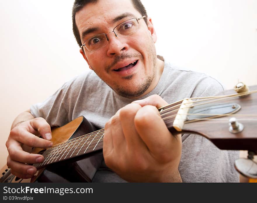 Funny man with glasses playing guitar. Funny man with glasses playing guitar