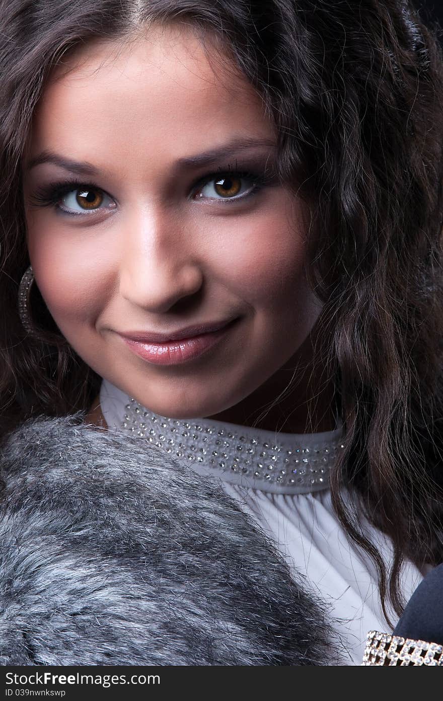 Pretty girl close-up portrait in fur coat