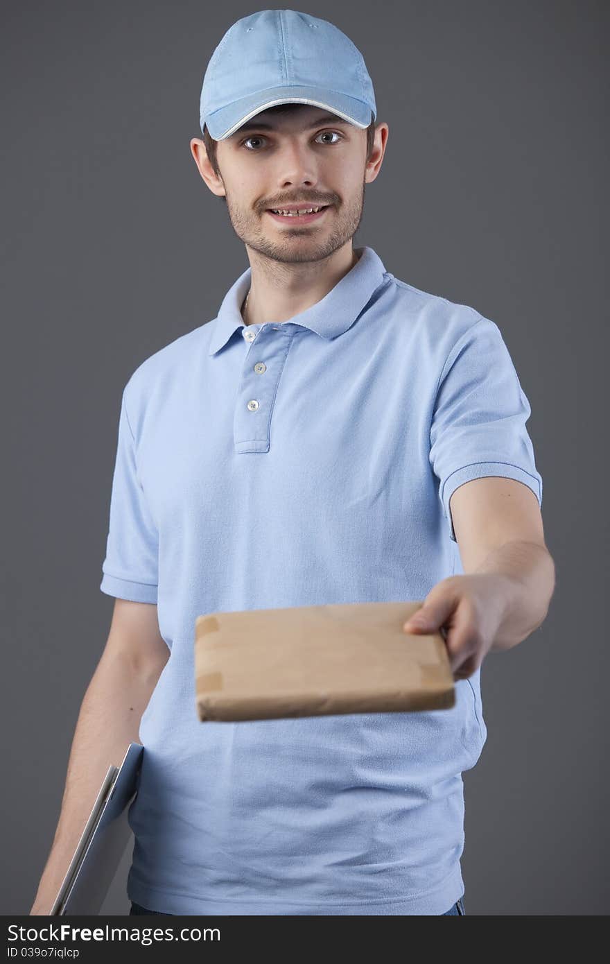 Delivery courier with small package in his hand