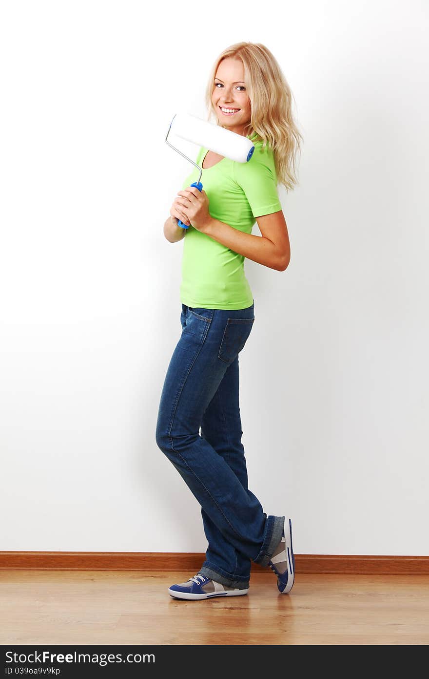 A woman with a brush against the wall