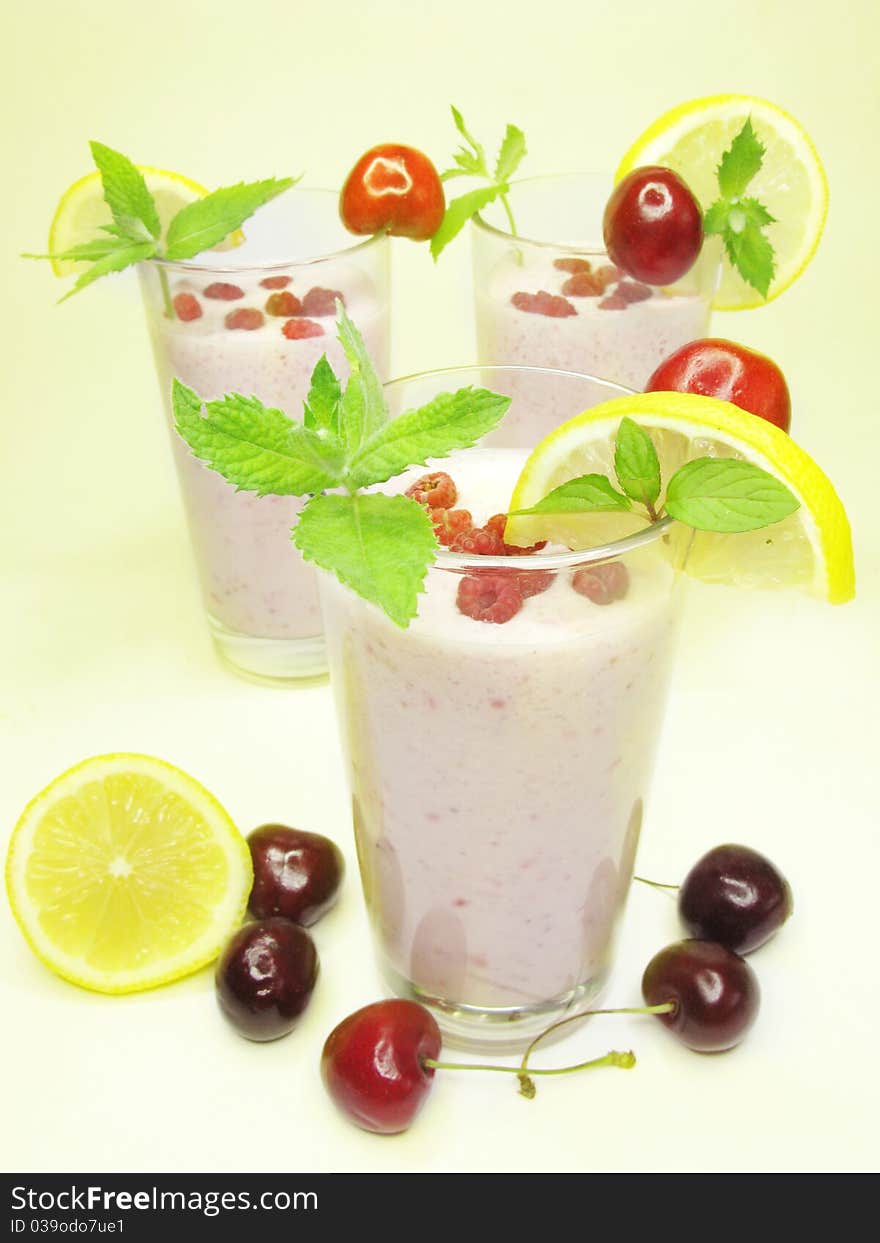 Three glasses of fruit cocktails with raspberry lemon and cherry. Three glasses of fruit cocktails with raspberry lemon and cherry