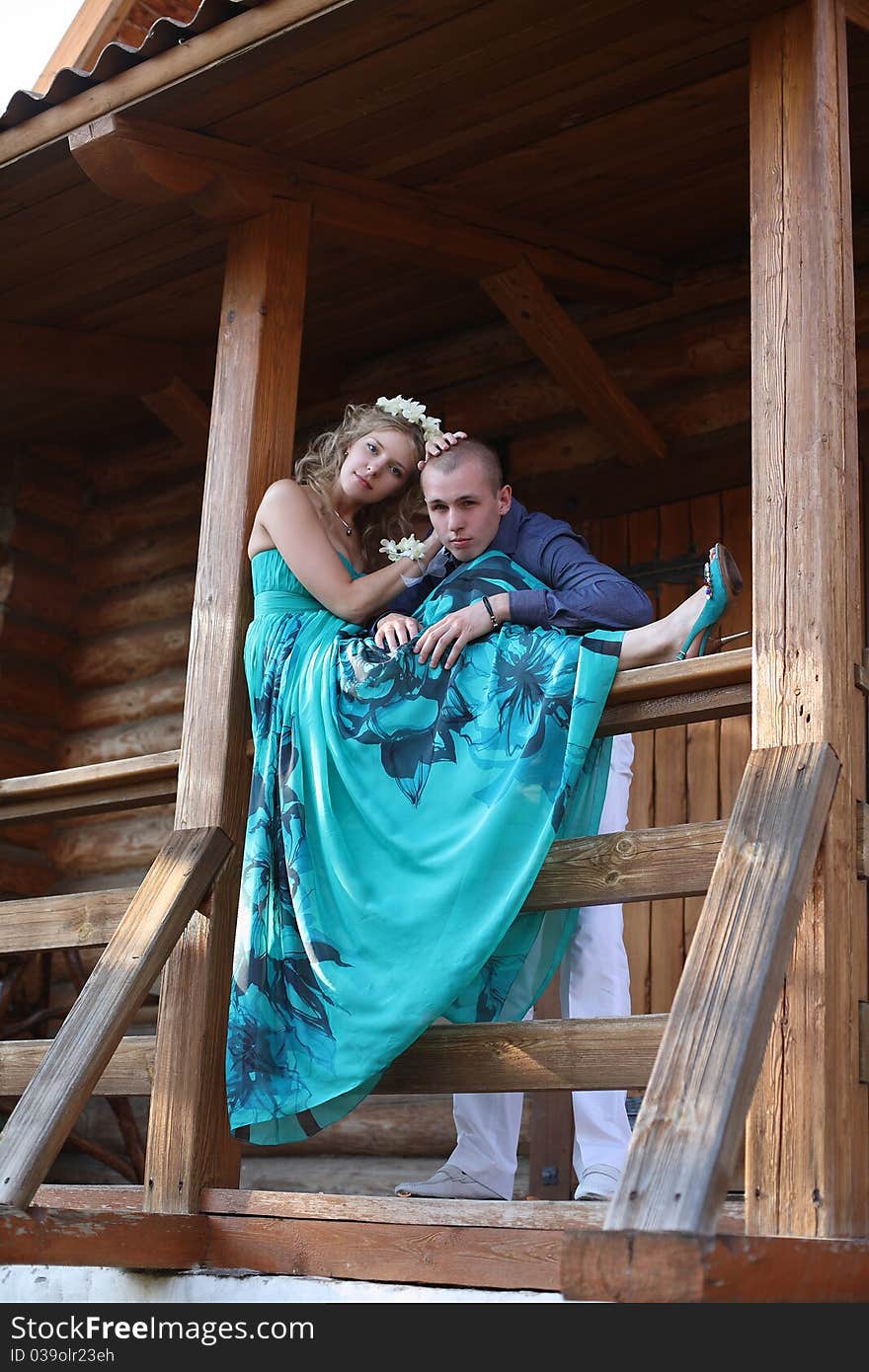 The young family costs on a porch of the under construction house. The young family costs on a porch of the under construction house