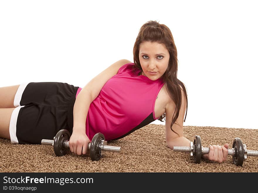 A woman is laying with some weights in her hands. A woman is laying with some weights in her hands.