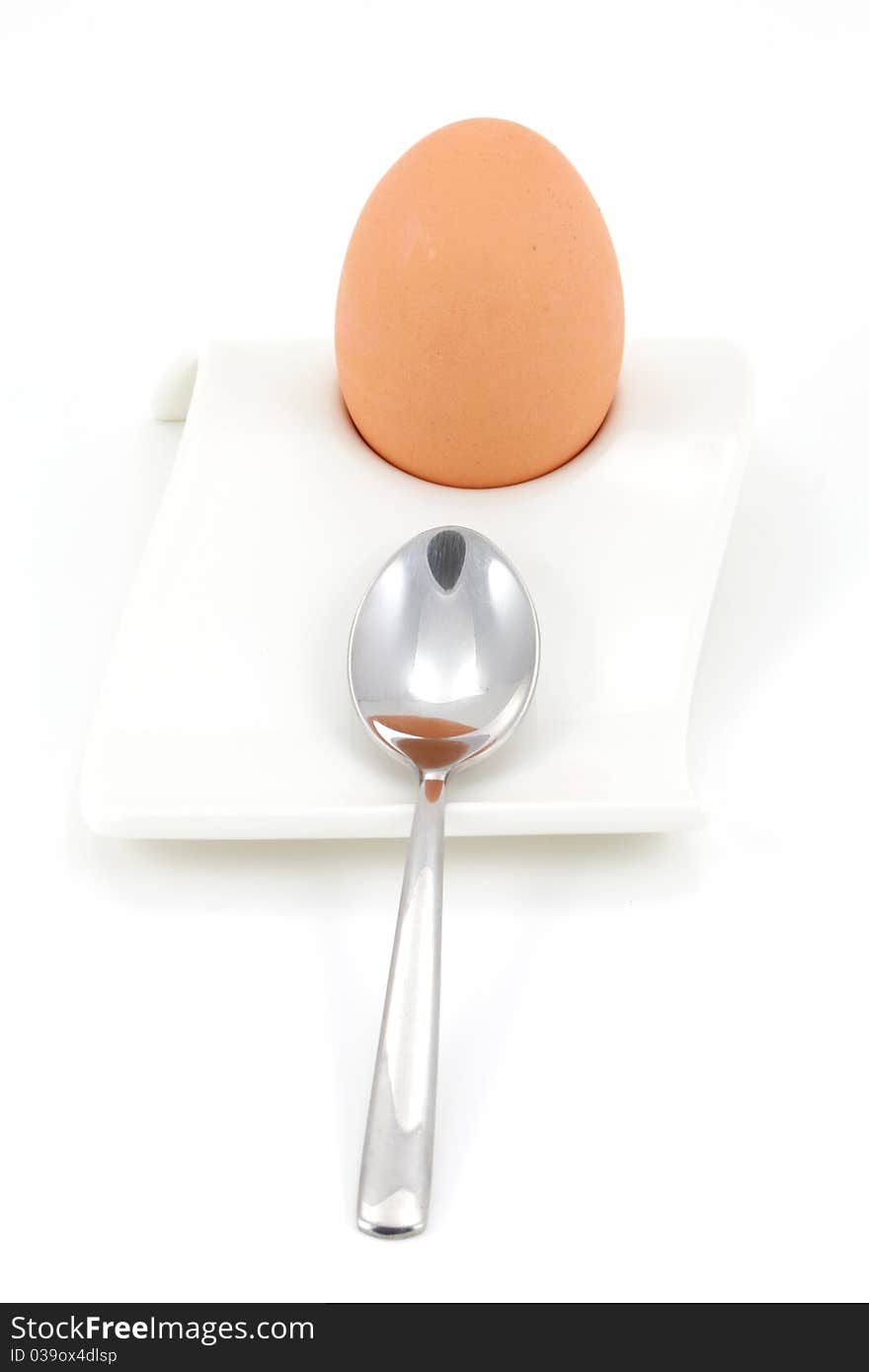 Soft boiled egg in egg holder with spoon