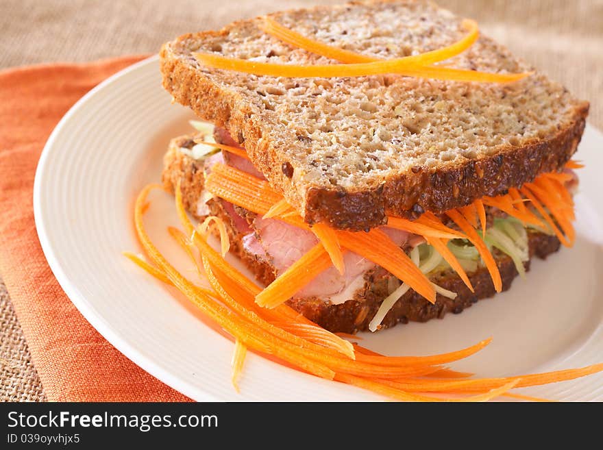 Tasty open sandwich with cucumber relish, smoked beef pastrami and sliced carrots on wholewheat bread. Tasty open sandwich with cucumber relish, smoked beef pastrami and sliced carrots on wholewheat bread