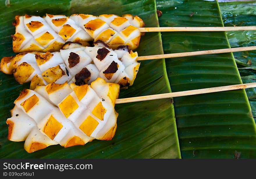 Three of grilled squid on banana leaves ready for eat