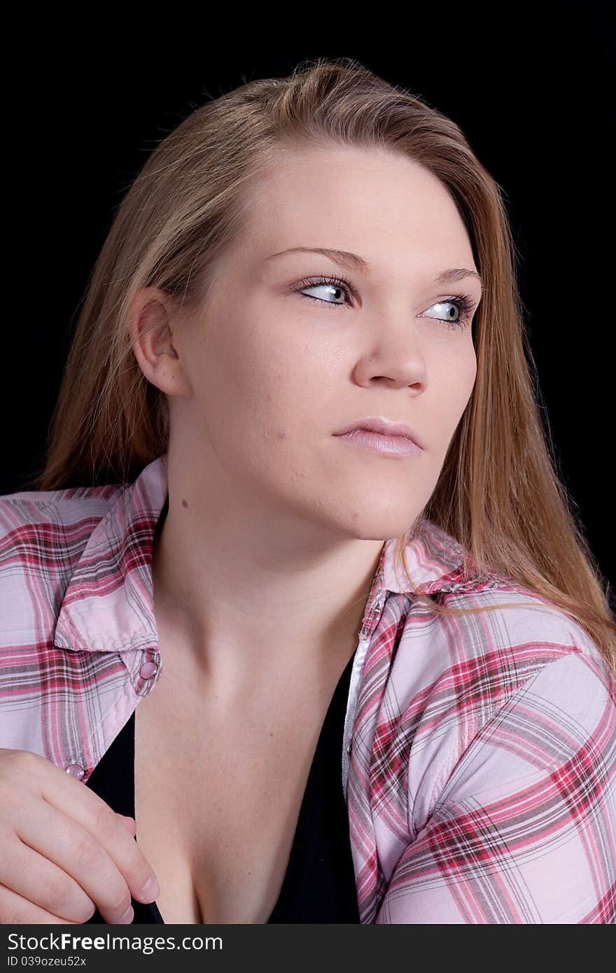 A beautiful blond girl wearing pink. There is a black background. A beautiful blond girl wearing pink. There is a black background.