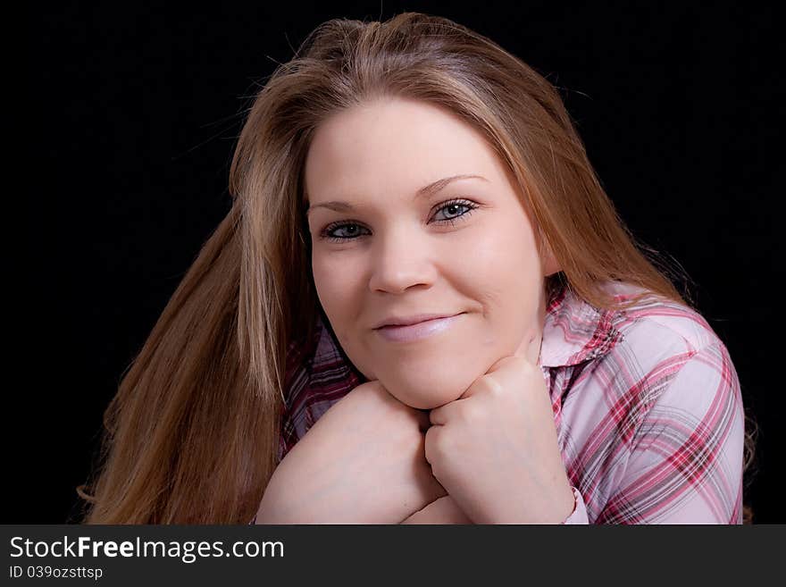 A beautiful blond girl wearing pink. There is a black background. A beautiful blond girl wearing pink. There is a black background.