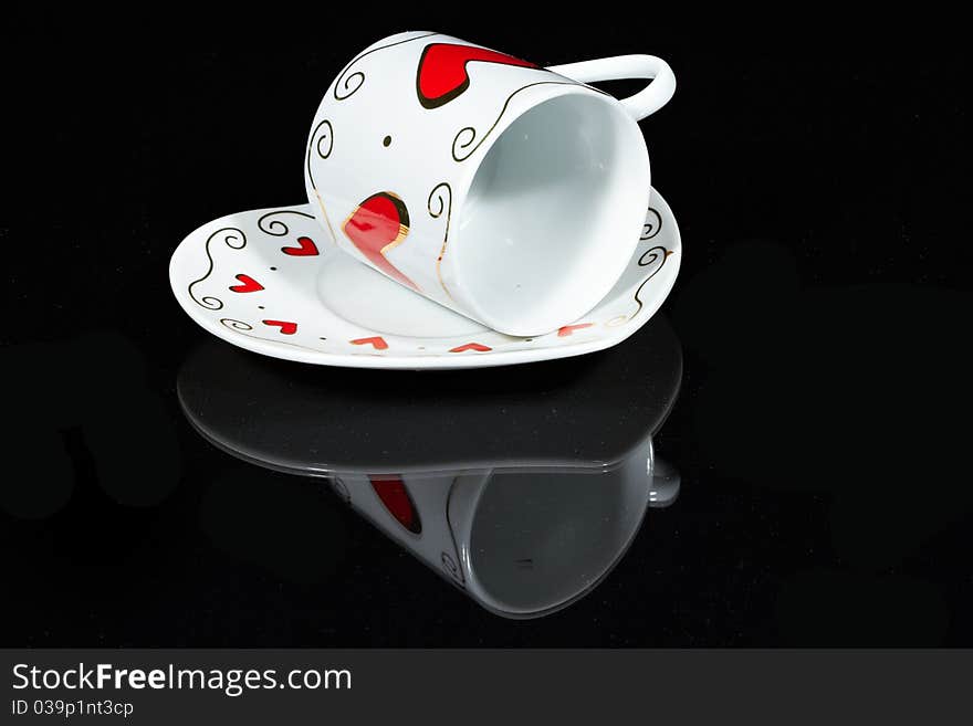 White cup with hearts.