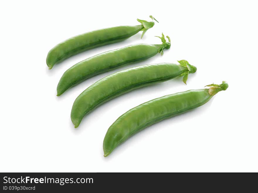 Pea pods. Green peas on a white background close-ups.