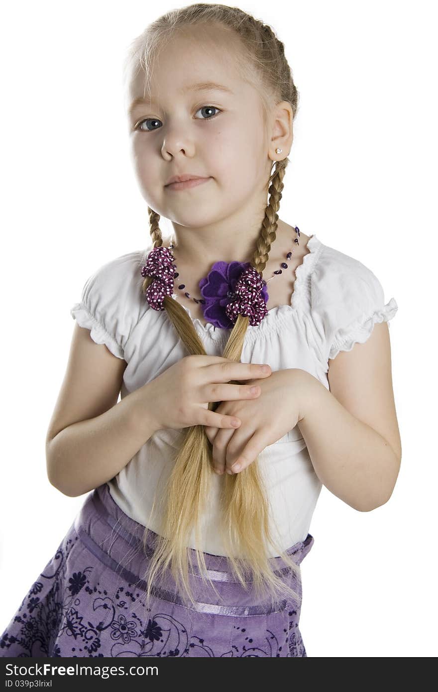 Little girl blonde with long plaits on a white background